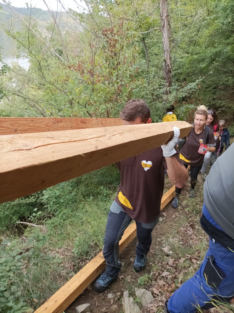 Dobrovolníci nesou dřevěné hranoly.